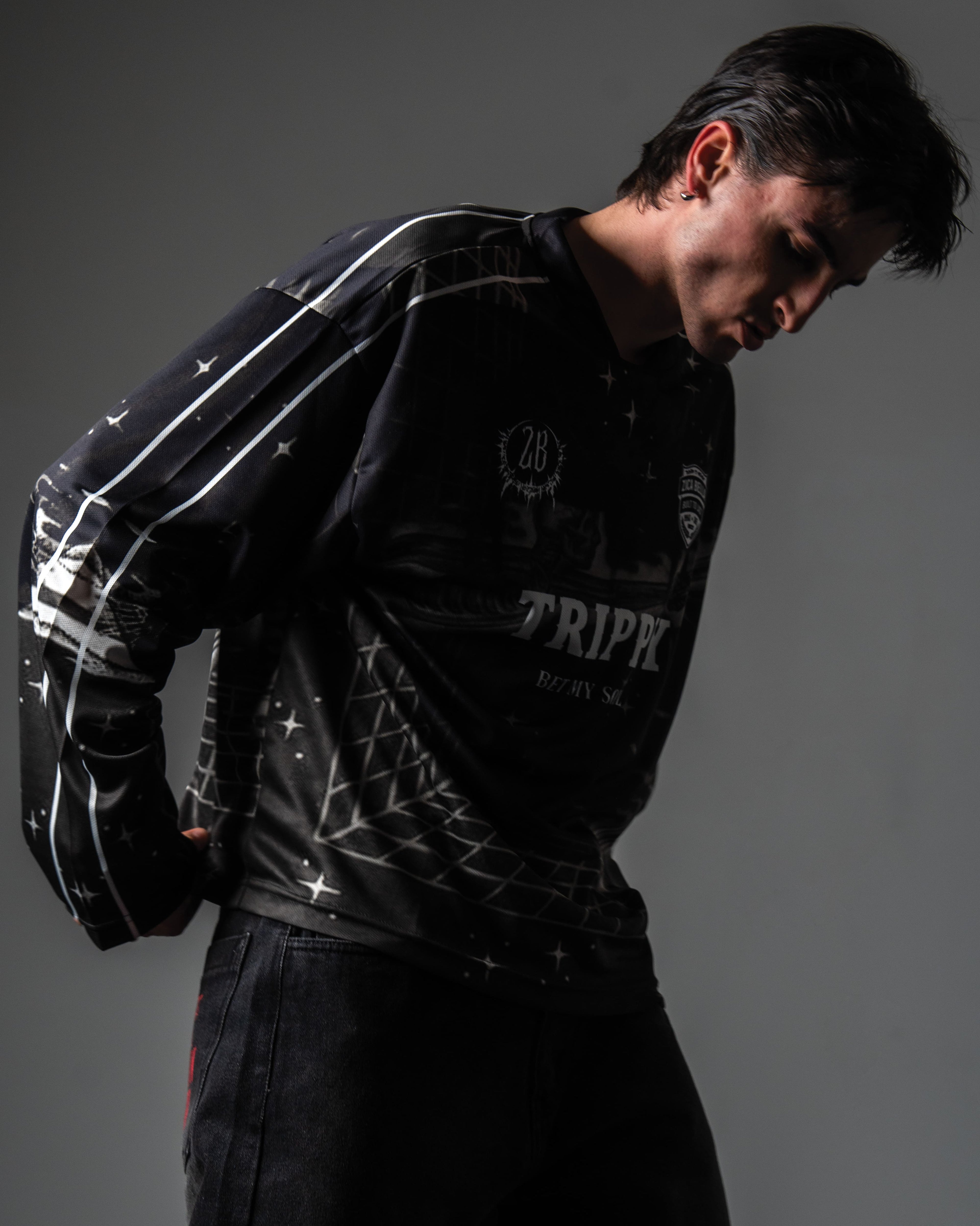 Side angle portrait highlighting the 3D grid illusion print on the TRPPY_22 streetwear jersey