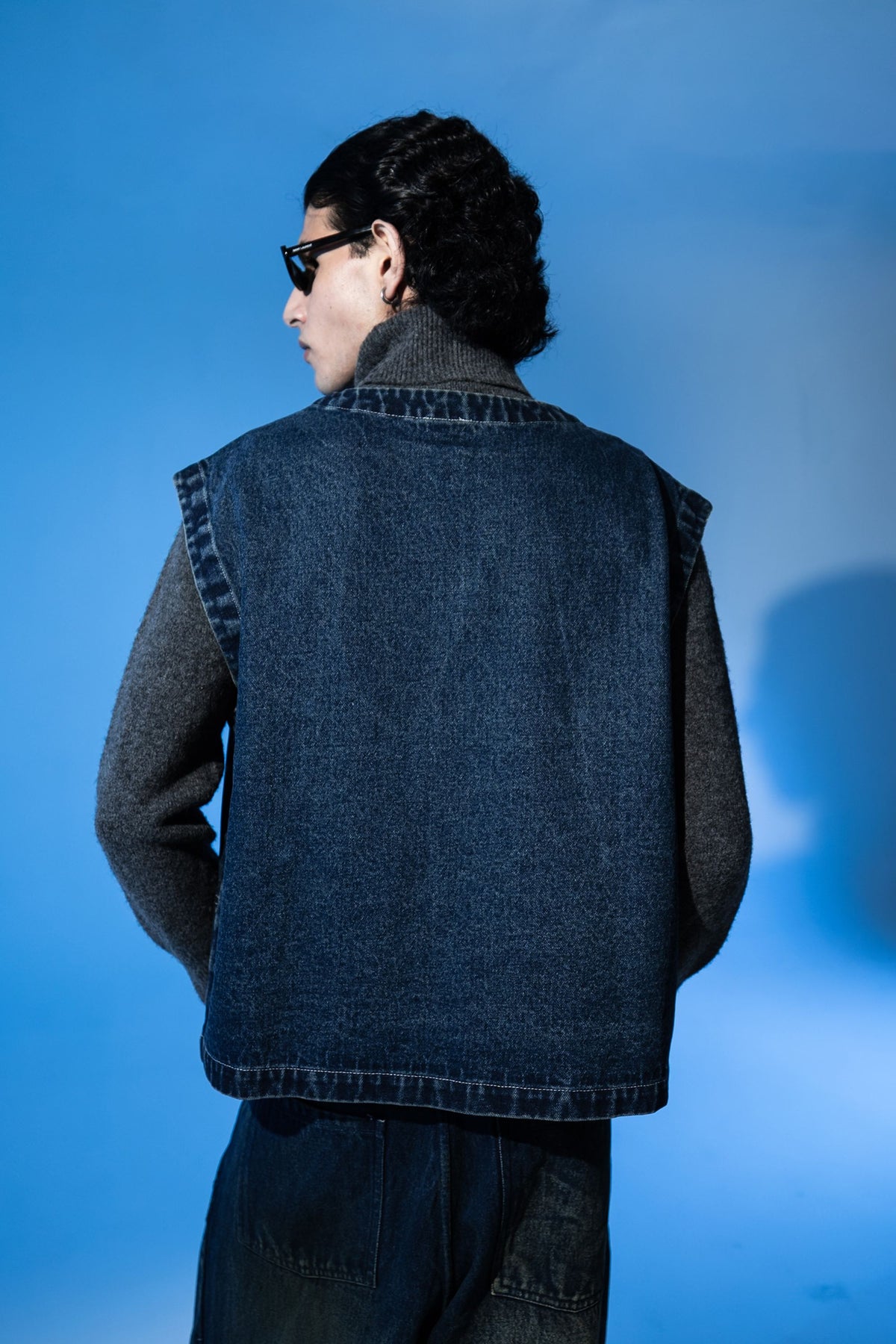 Back view of premium sleeveless denim jacket for men highlighting clean stitching and tailored shape