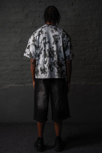 Back view of oversized grey black acid wash t-shirt featuring an abstract pattern