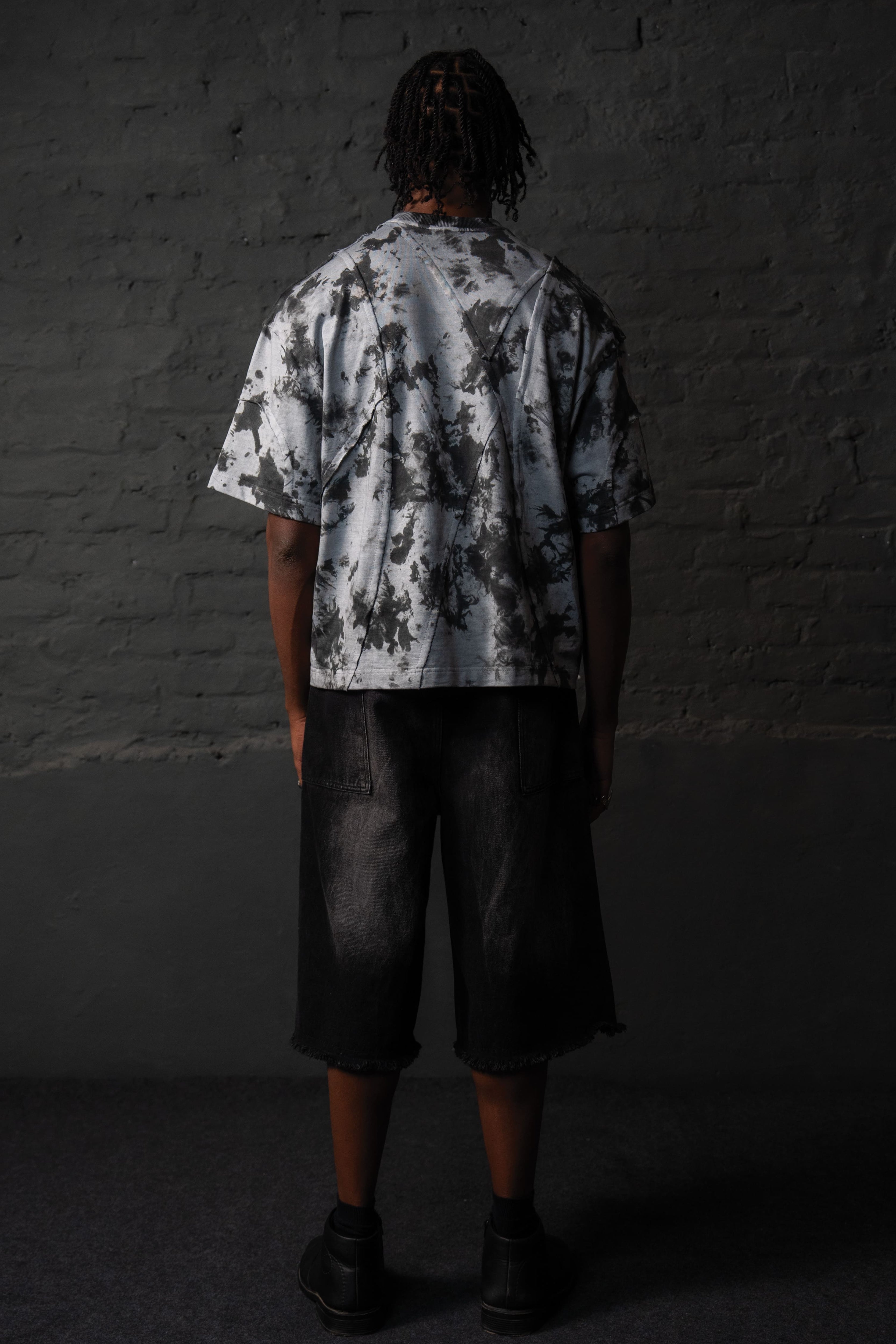 Back view of oversized grey black acid wash t-shirt featuring an abstract pattern