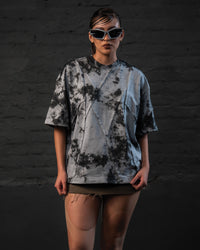 Female model styling oversized streetwear t-shirt in a futuristic urban look, full front view