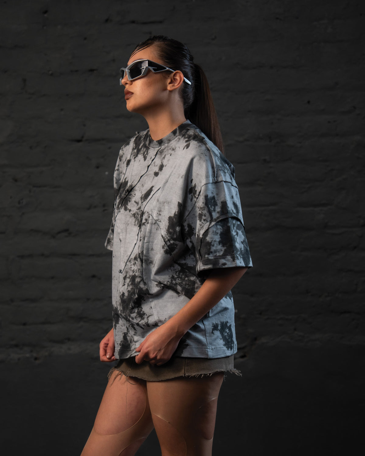 Side profile of SCAR_ASH oversized acid wash streetwear t-shirt in grey black abstract wash