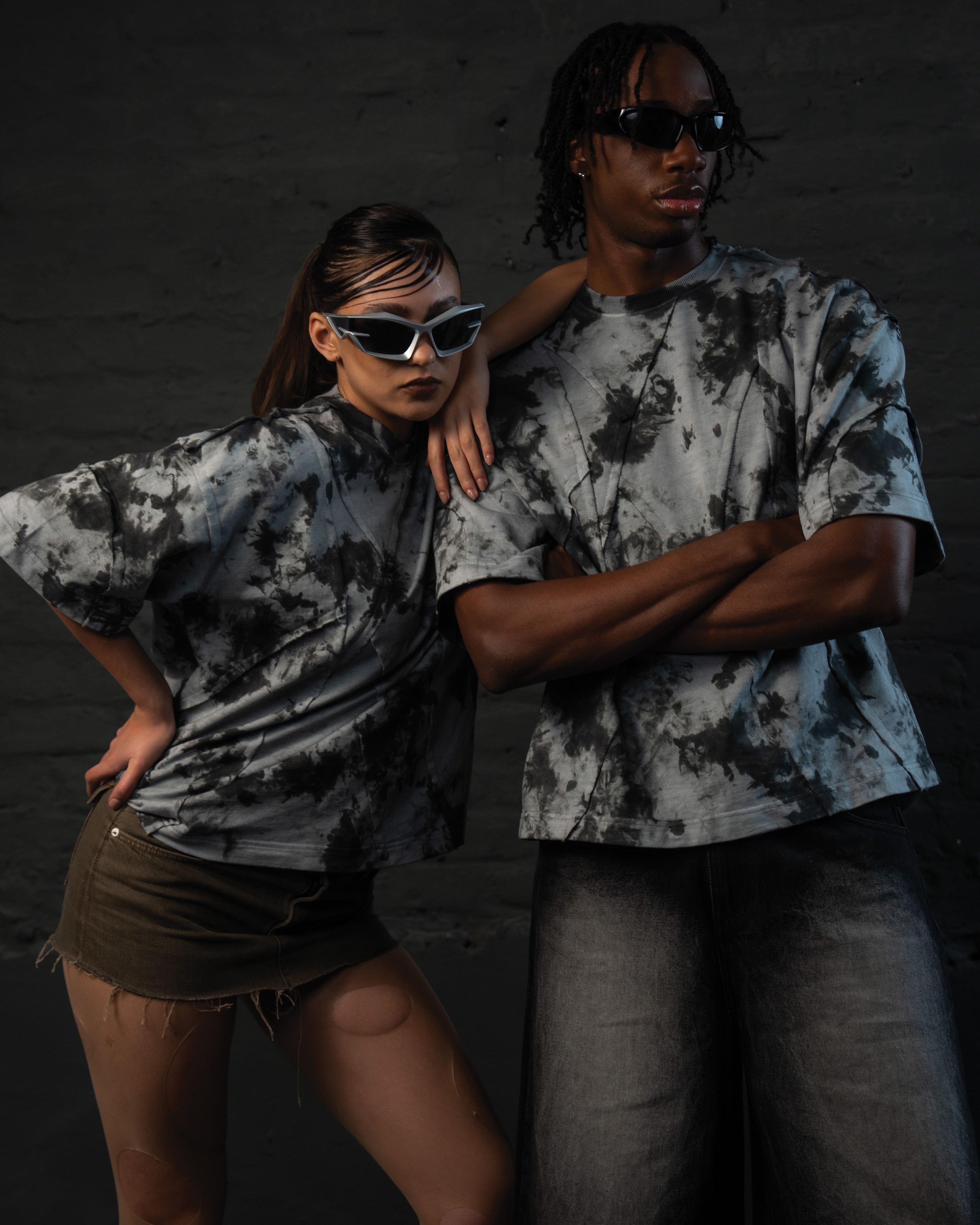 Couple styling oversized acid wash streetwear t-shirts in a modern luxury fashion aesthetic