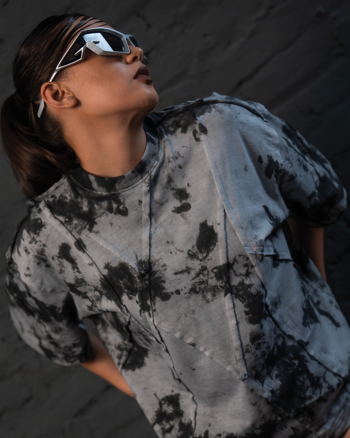 Editorial close-up of SCAR_ASH oversized designer t-shirt with futuristic