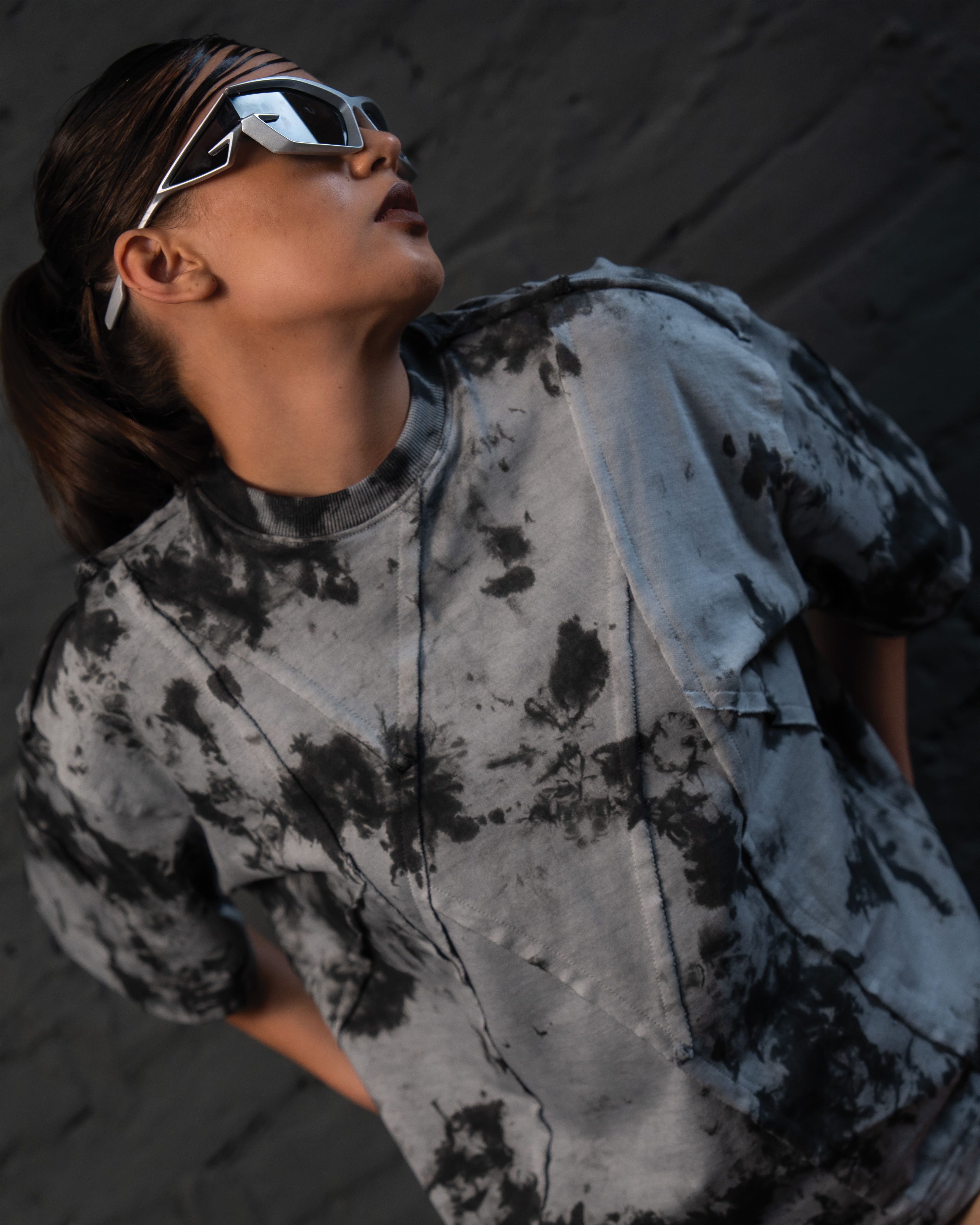 Editorial close-up of SCAR_ASH oversized designer t-shirt with futuristic