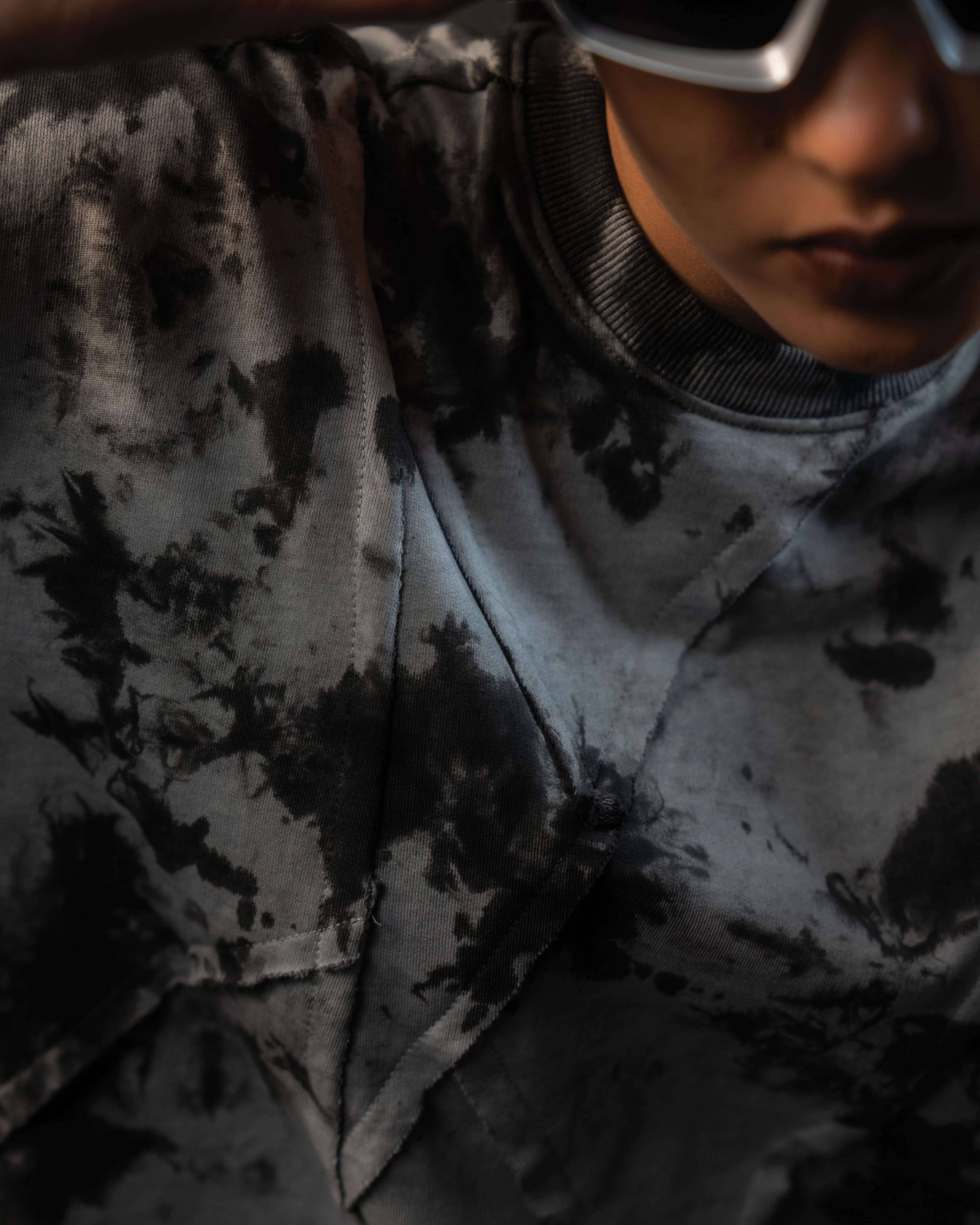 Close-up neckline and custom seam detailing of SCAR_ASH oversized t-shirt
