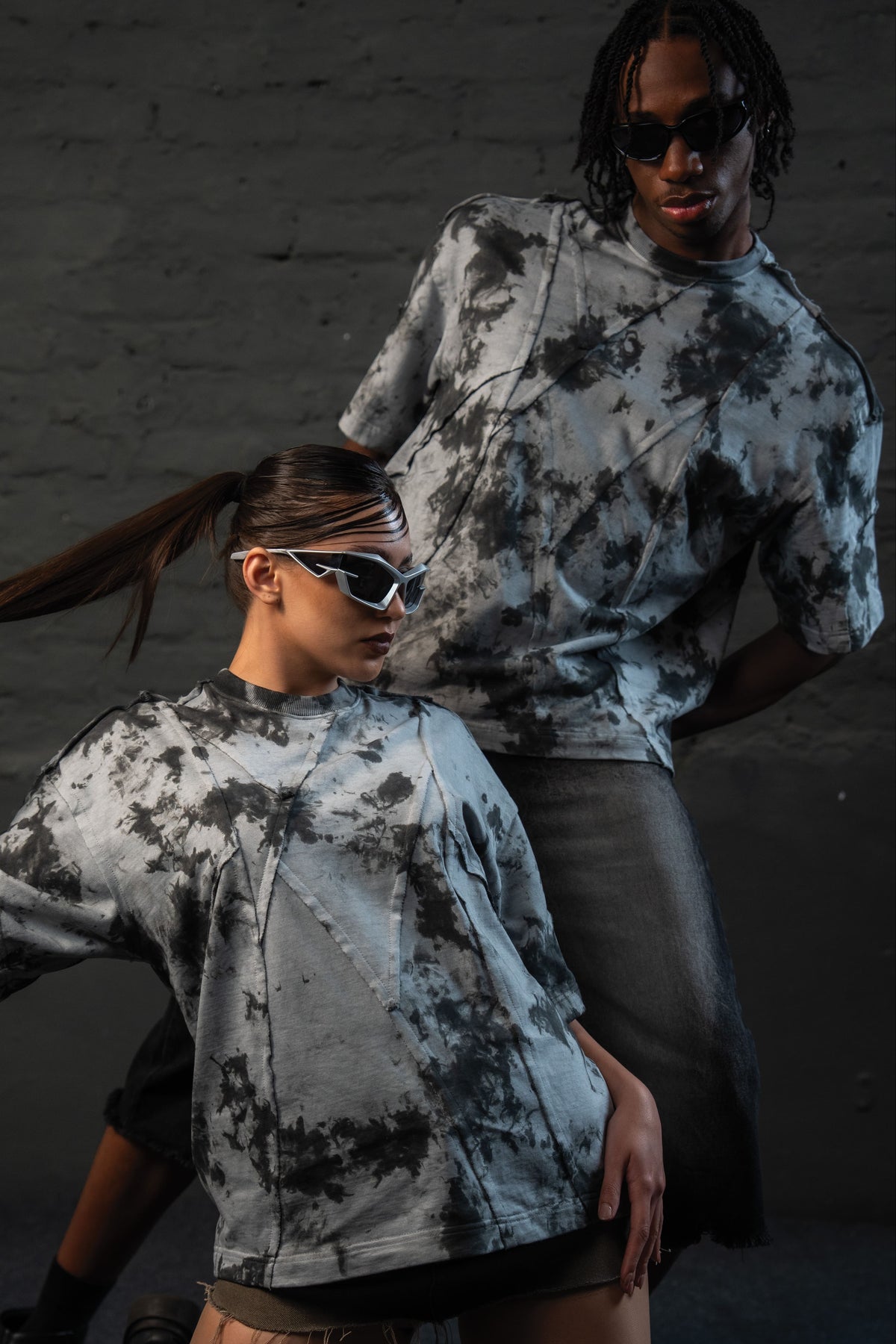 Models styling SCAR_ASH oversized acid wash t-shirt in a luxury urban fashion editorial