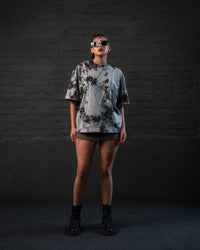 Full-length front view of oversized acid wash streetwear t-shirt in grey black