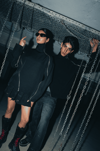 Black oversized shirt with a relaxed fit, crafted from eco-conscious materials, featuring modern double zip details for an urban, streetwear-inspired look