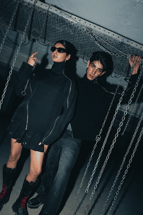 Black oversized shirt with a relaxed fit, crafted from eco-conscious materials, featuring modern double zip details for an urban, streetwear-inspired look