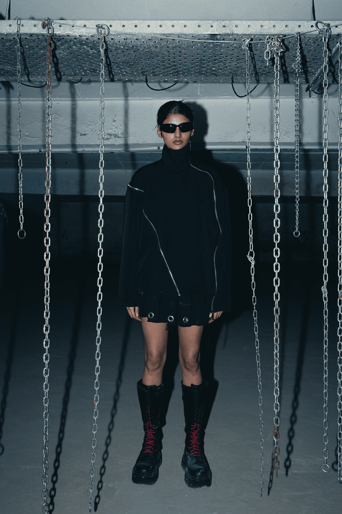 Black oversized shirt with a relaxed fit, featuring a modern design and double zip detail, made from sustainable materials
