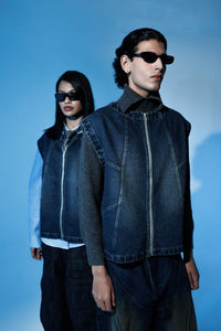 Sleeveless denim jacket worn in layered streetwear outfit for men