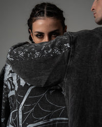 Close-up detail of the premium screenprinted spiderweb artwork on a washed charcoal oversized long sleeve tee
