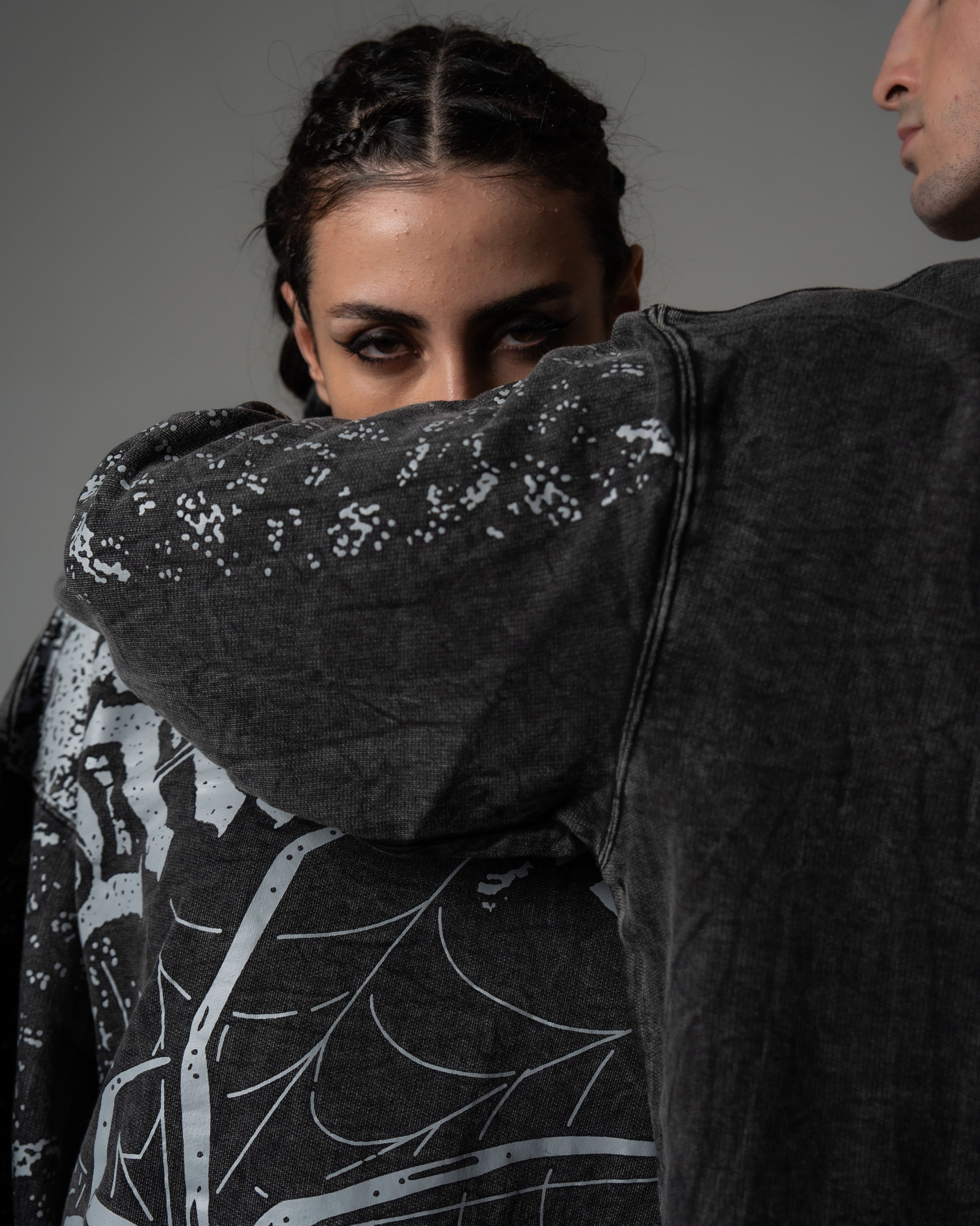 Close-up detail of the premium screenprinted spiderweb artwork on a washed charcoal oversized long sleeve tee