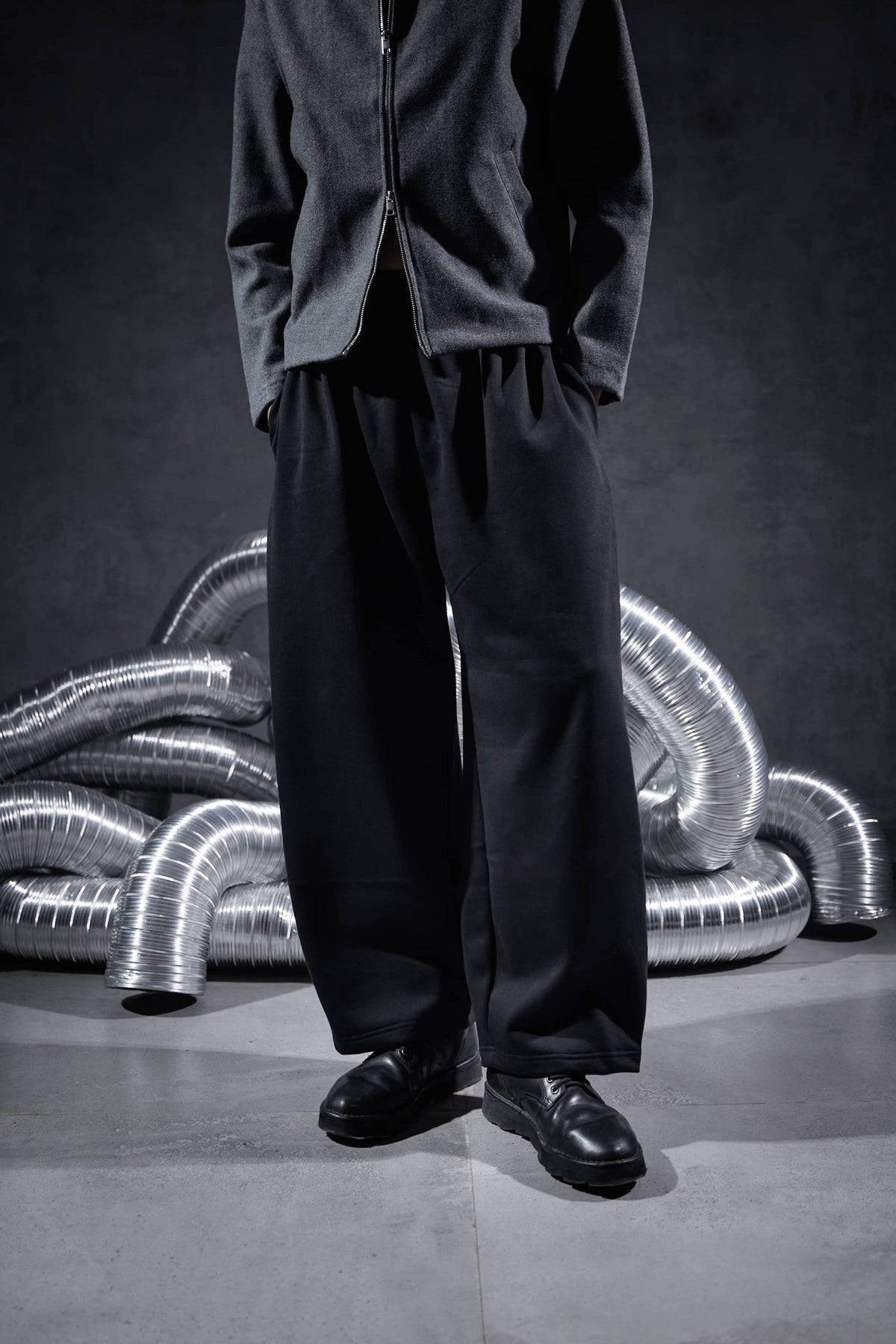 Black oversized streetwear joggers with relaxed wide leg fit, premium men's pants showing natural drape and modern urban street fashion style
