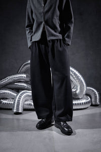 Black oversized streetwear joggers with relaxed wide leg fit, premium men's pants showing natural drape and modern urban street fashion style