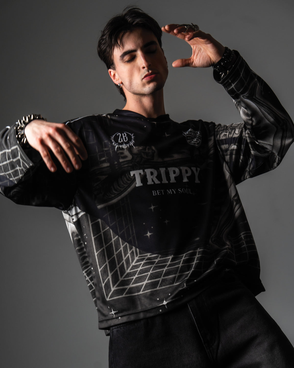 Male model wearing the oversized TRPPY_22 long sleeve jersey styled with baggy black denim jeans