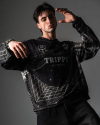 Male model wearing the oversized TRPPY_22 long sleeve jersey styled with baggy black denim jeans