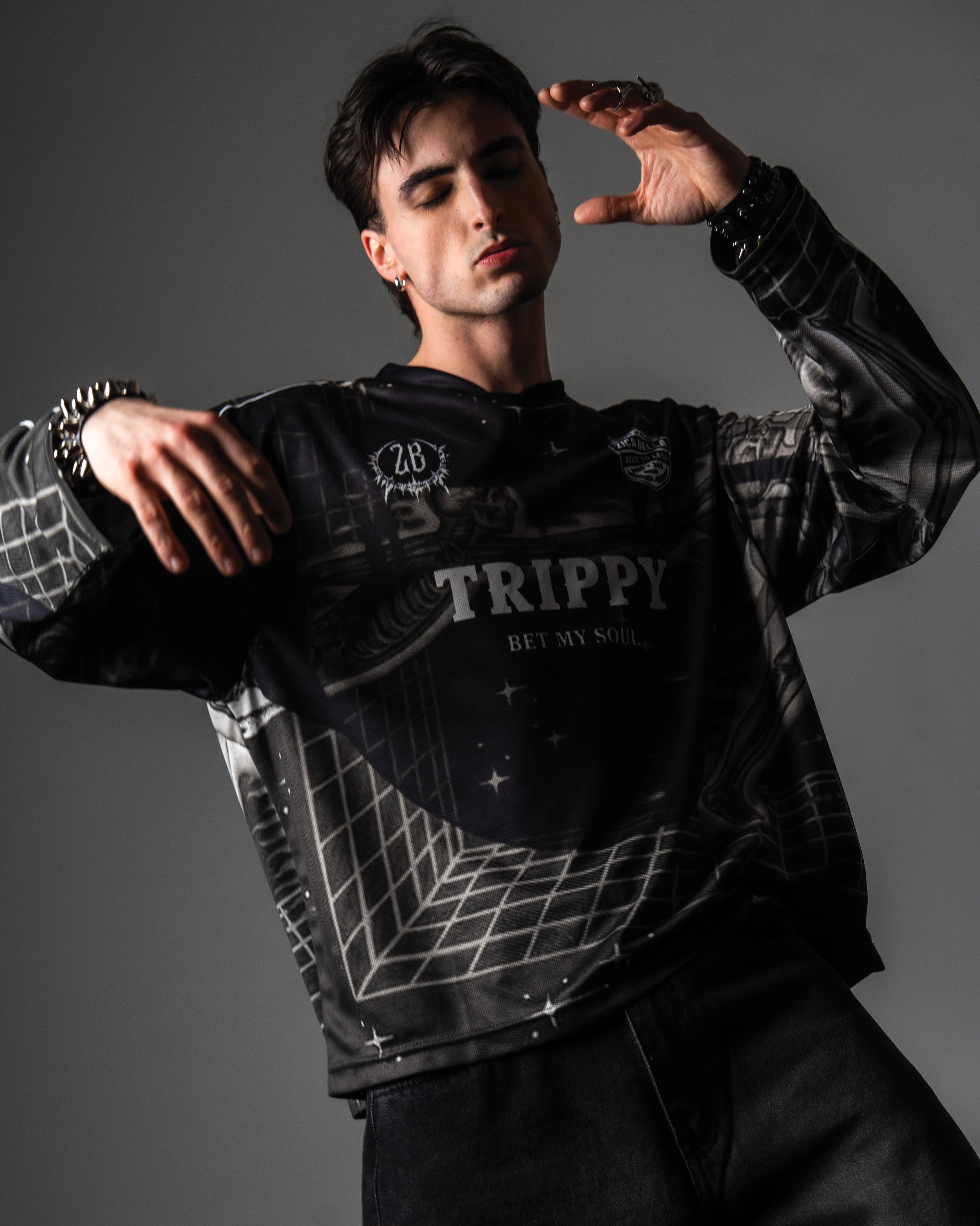 Male model wearing the oversized TRPPY_22 long sleeve jersey styled with baggy black denim jeans