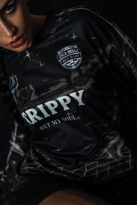 Front portrait of a male model wearing the black TRPPY_22 oversized long sleeve streetwear jersey.
