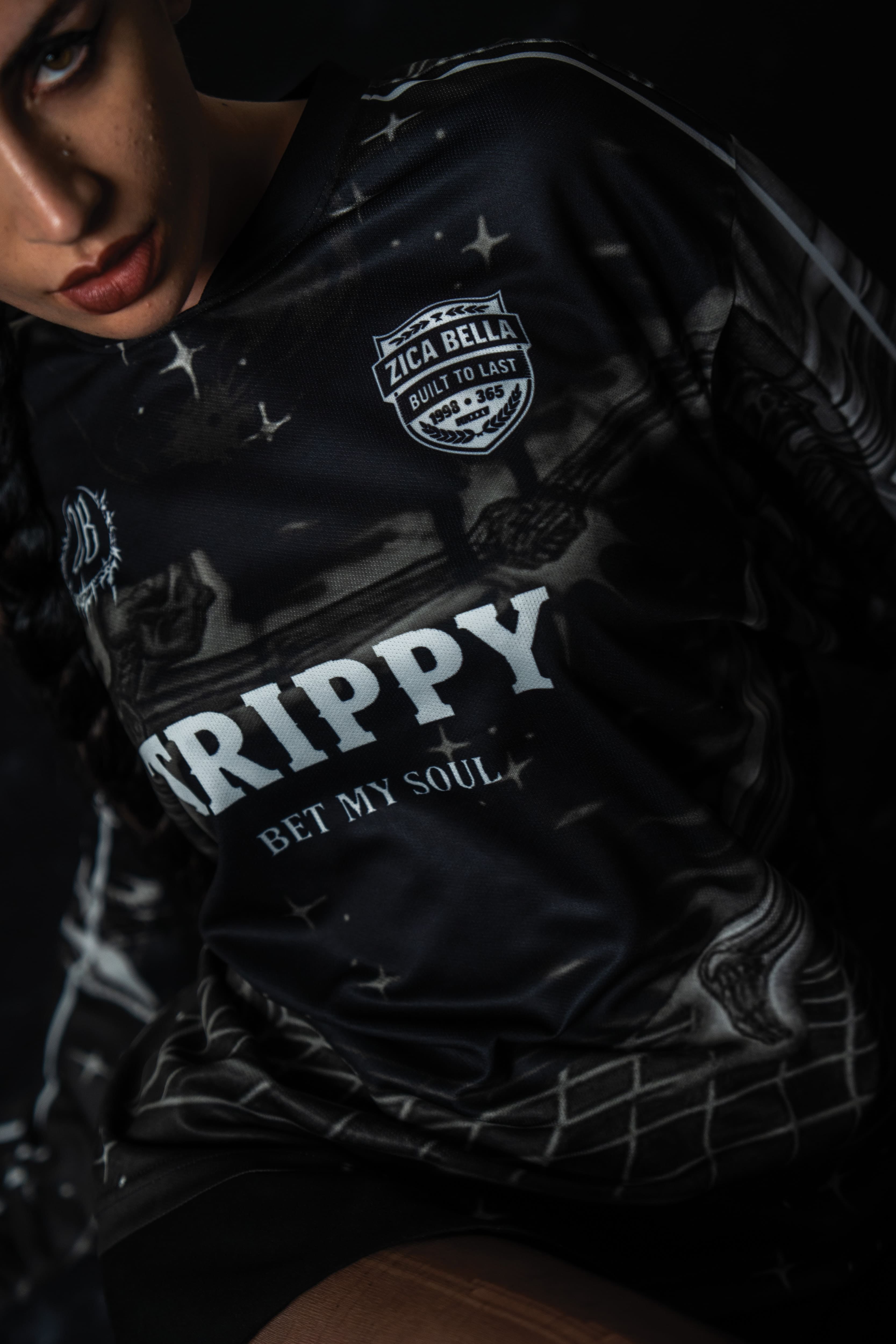 Front portrait of a male model wearing the black TRPPY_22 oversized long sleeve streetwear jersey.