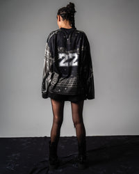 Full back view of a female model showing the relaxed drop shoulder fit of the oversized TRPPY_22 jersey