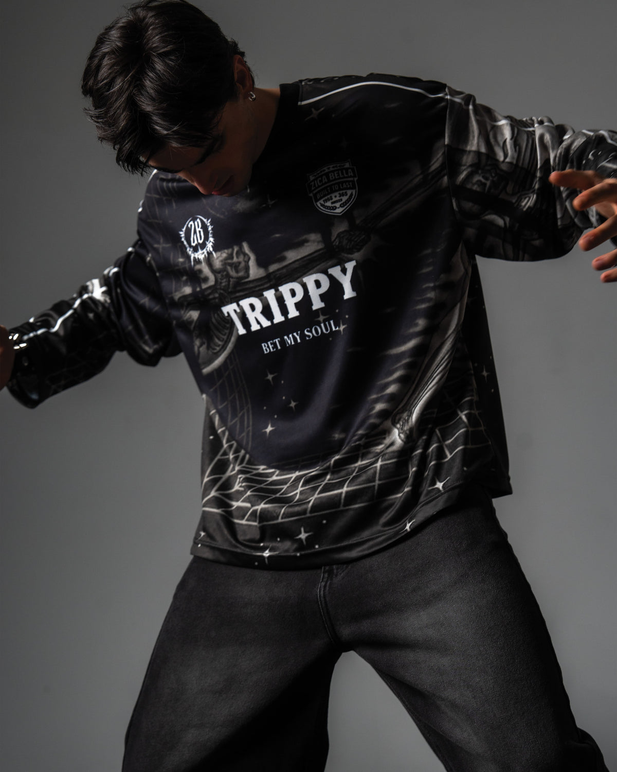 Studio portrait highlighting the relaxed oversized fit and grey cyber grid graphics of the TRPPY_22 jersey