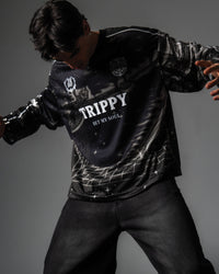 Studio portrait highlighting the relaxed oversized fit and grey cyber grid graphics of the TRPPY_22 jersey