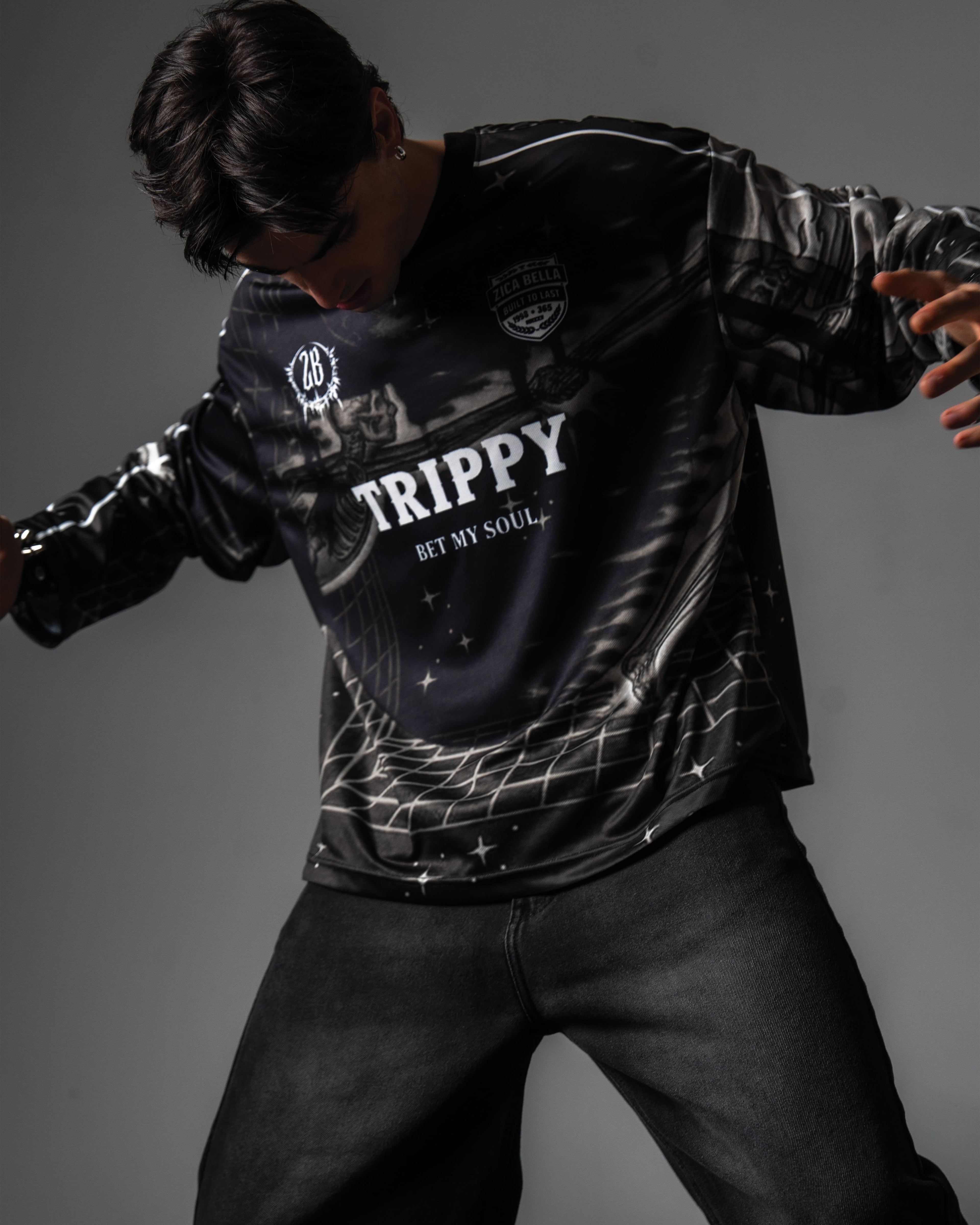 Studio portrait highlighting the relaxed oversized fit and grey cyber grid graphics of the TRPPY_22 jersey