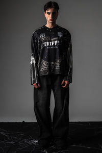 Studio lookbook shot of male model styling oversized TRPPY_22 long sleeve streetwear jersey.
