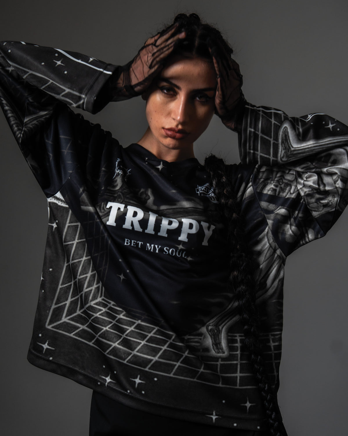 Front portrait of a female model styling the oversized black TRPPY_22 long sleeve streetwear jersey