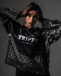 Front portrait of a female model styling the oversized black TRPPY_22 long sleeve streetwear jersey