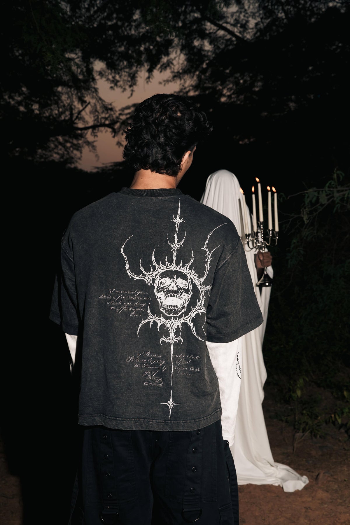 Black streetwear t-shirt showcasing symbolic back print artwork on soft 100% cotton fabric