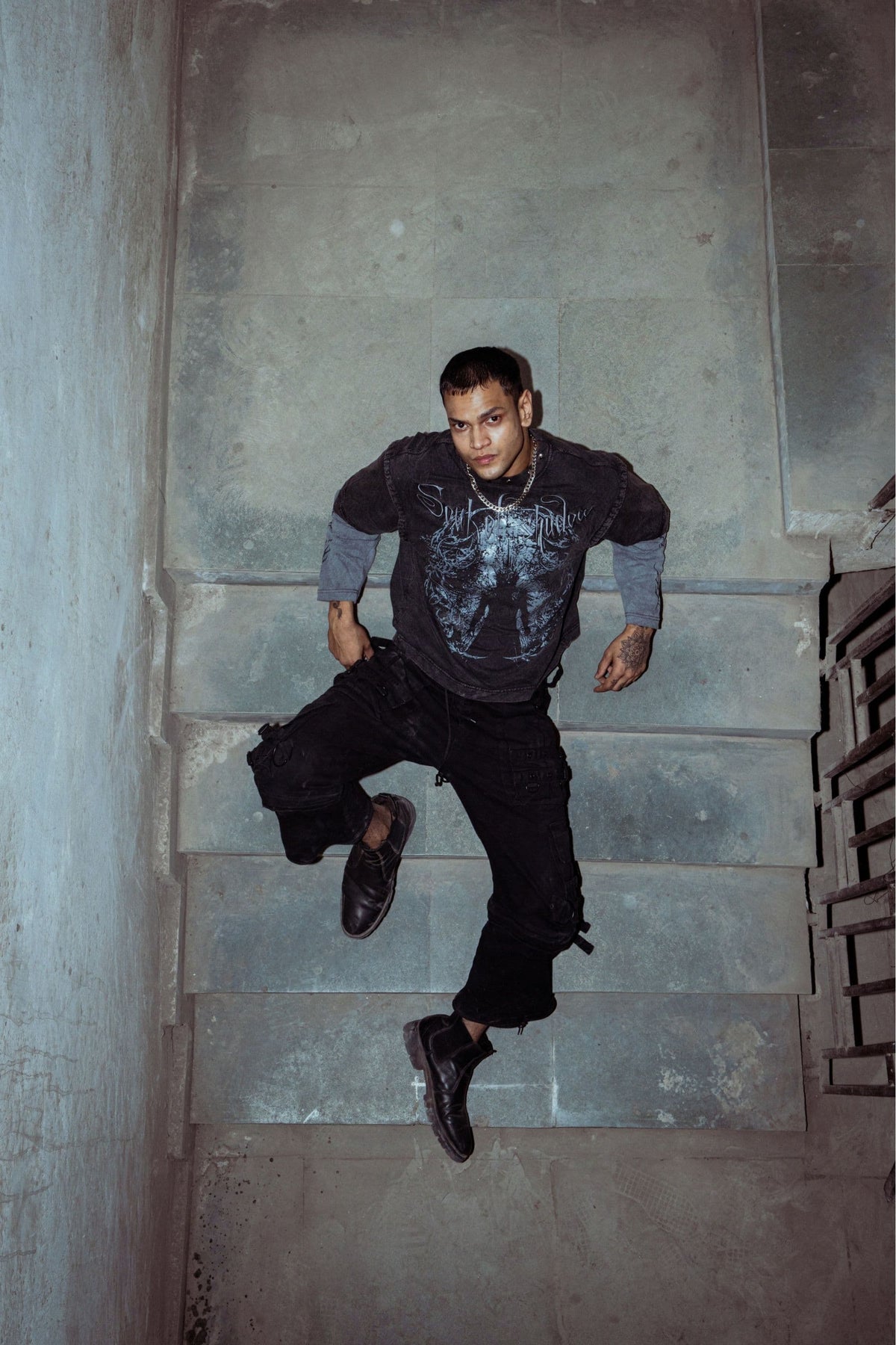 T-shirt made from premium 100% cotton, featuring a relaxed fit with a bold graphic print and washed black texture