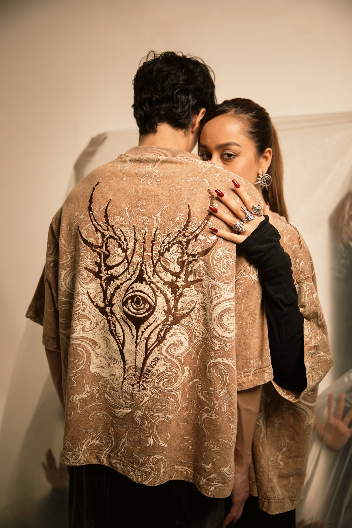 Symbolic embroidery on graphic streetwear t-shirt featuring abstract psychological horror detailing