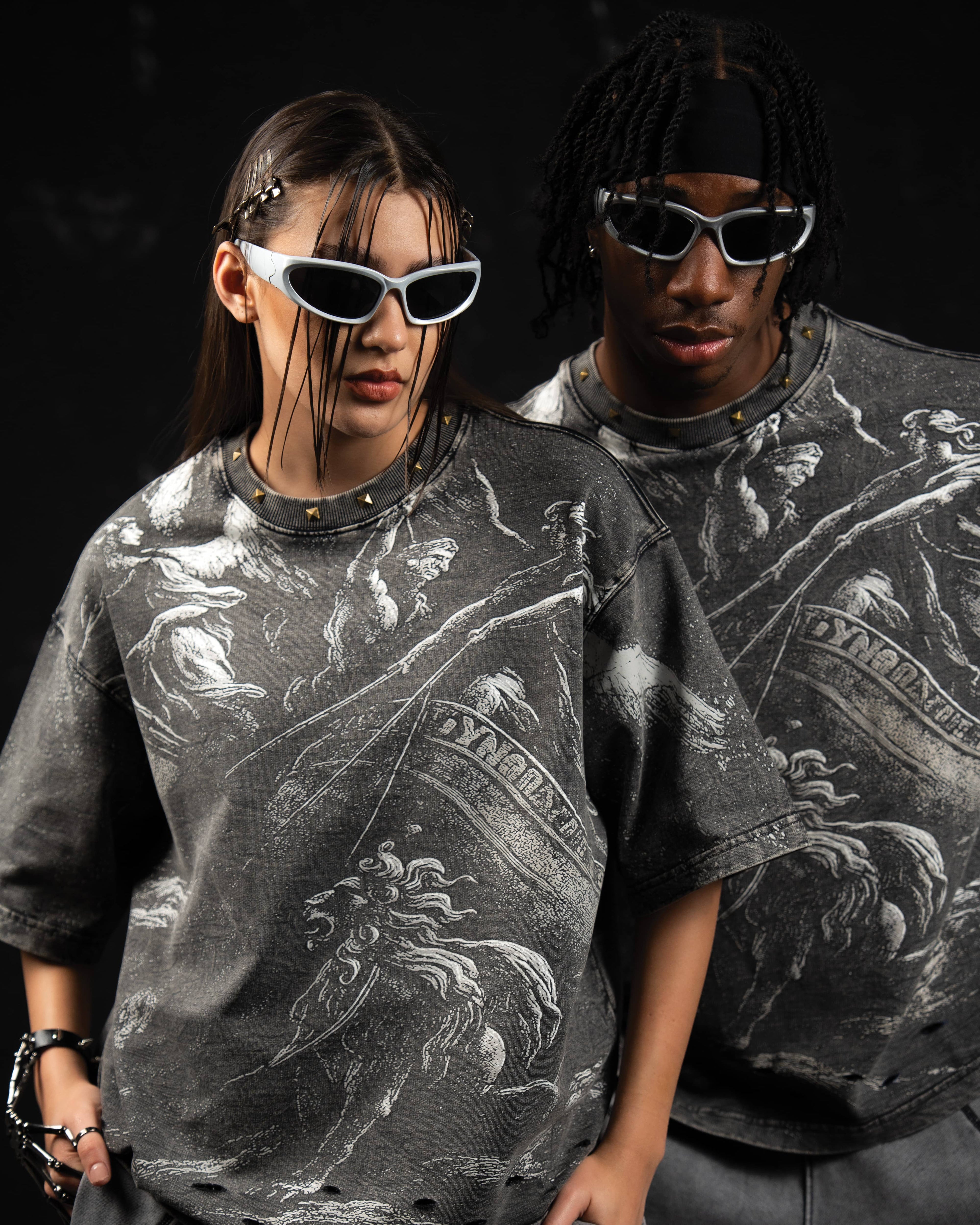 Studio fashion shot of male and female models styling oversized charcoal graphic t-shirts
