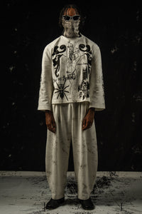 Relaxed fit unisex darkwear outfit styled with wide-leg pants and a graphic full sleeve t-shirt