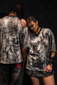 Male and female models showcasing a matching set of grey and black oversized graphic jerseys