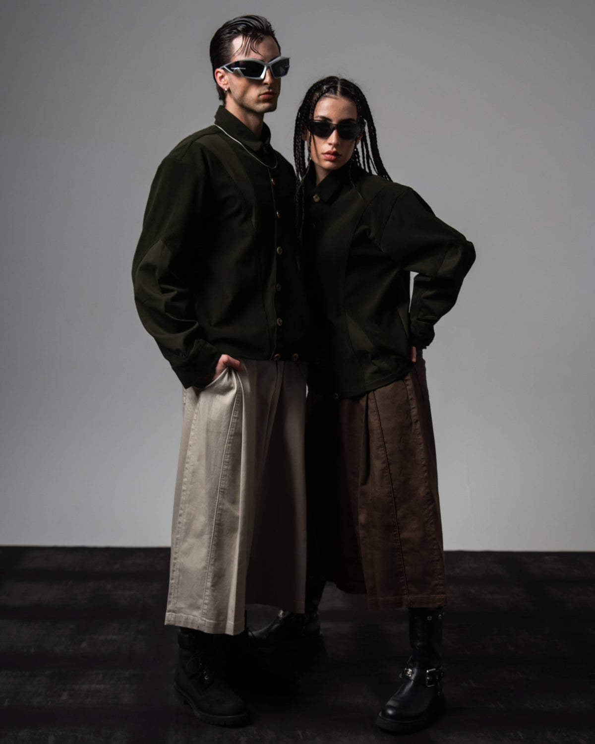 Male and female models showcasing couple styling in matching dark olive oversized shirts