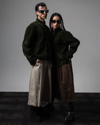 Male and female models showcasing couple styling in matching dark olive oversized shirts
