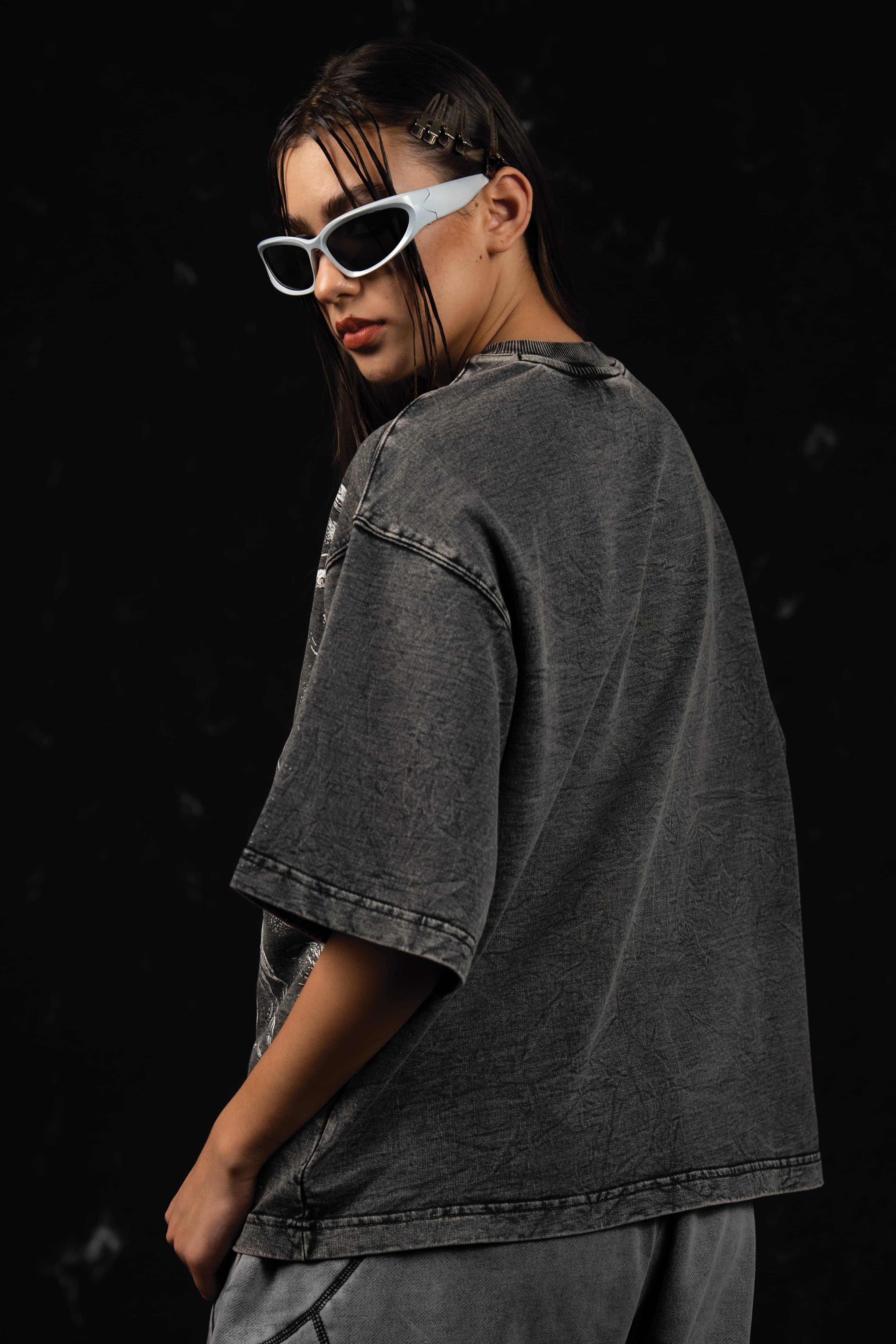 Back view of a woman showcasing the faded vintage finish of an oversized charcoal t-shirt