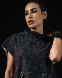 Portrait of a woman styling a washed charcoal oversized hooded graphic tee