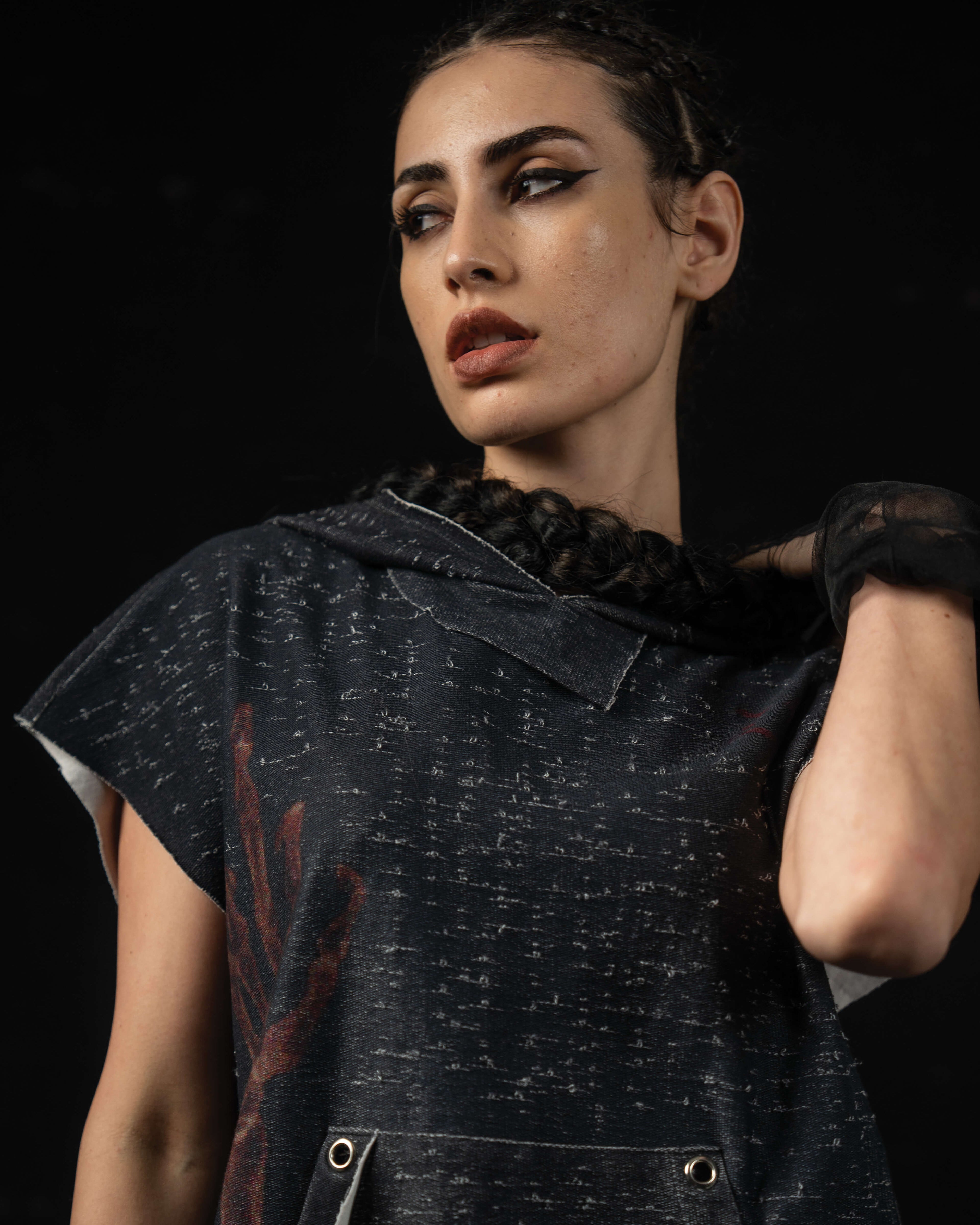 Portrait of a woman styling a washed charcoal oversized hooded graphic tee