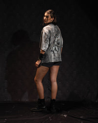 Full-length rear view of a woman displaying the drape of an oversized graphic jersey