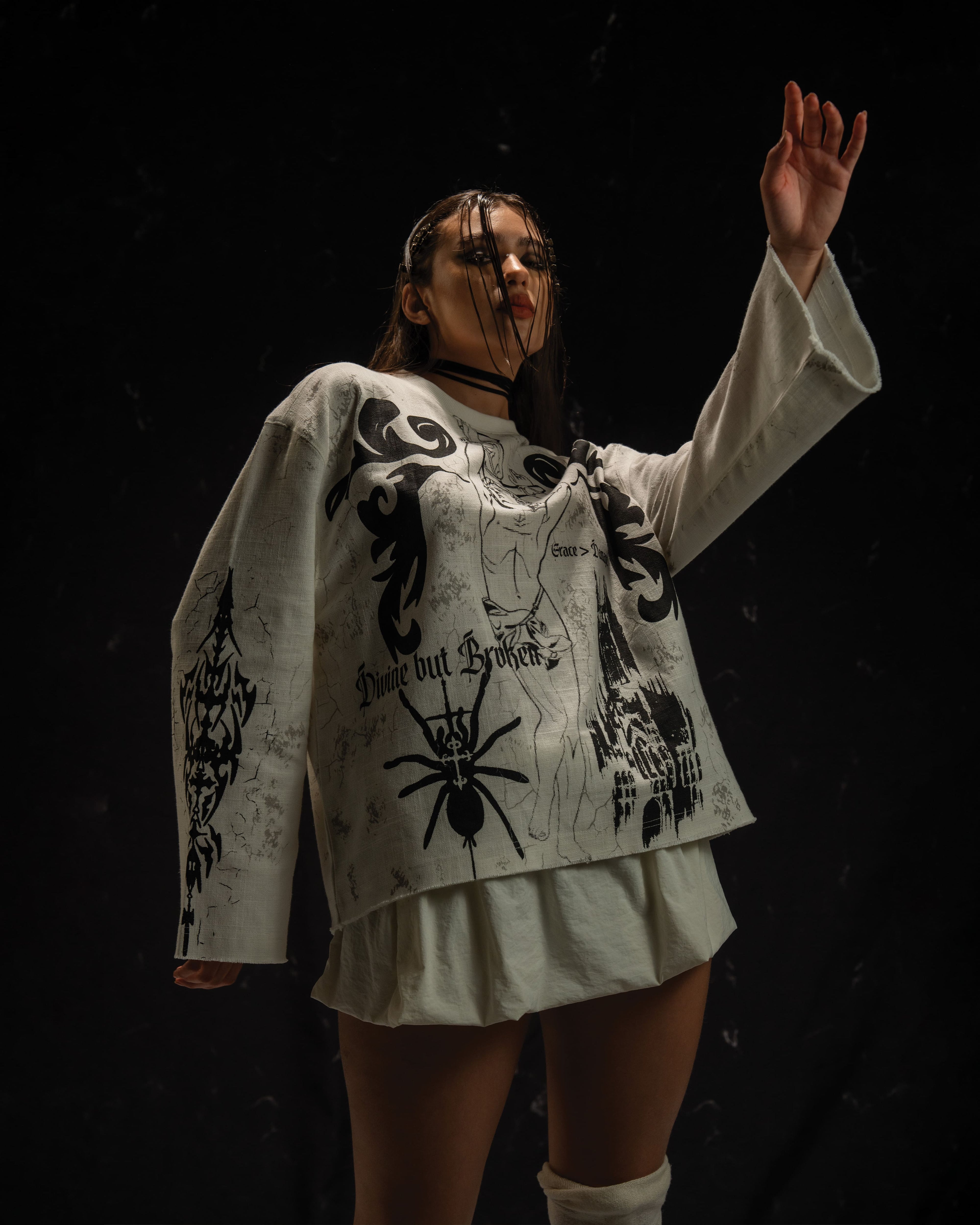 Women's oversized darkwear outfit styled with gothic graphic streetwear elements