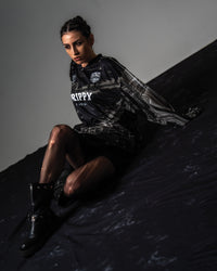High fashion studio shot of a female model styling the oversized black TRPPY_22 streetwear jersey 