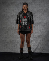 Front full-length shot of a woman modeling the ZBRIX_26 oversized grunge graphic jersey as a streetwear dress