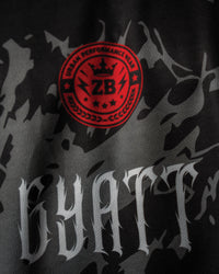 Macro close-up view of the custom 'GYATT ' text print texture and high-density circular badge detailing