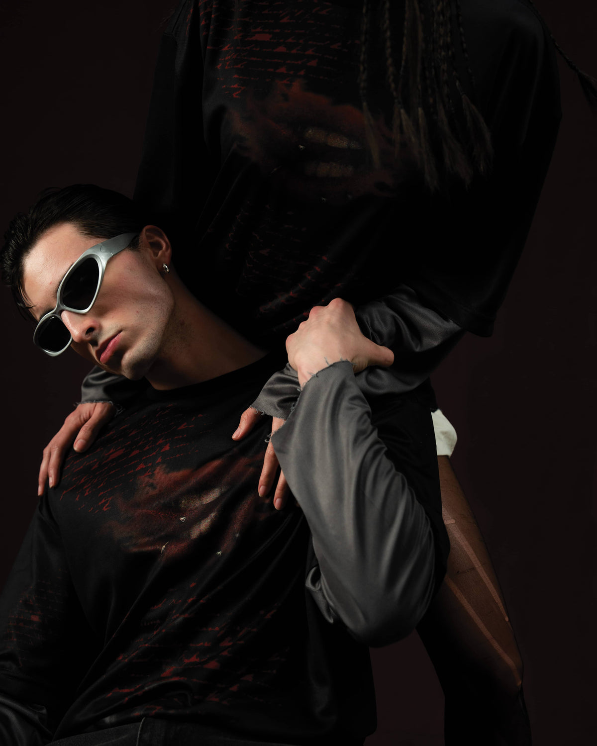 Zica Bella Bloodzic Jersey 01 black oversized streetwear jersey with red graphic styled on male and female models in editorial interaction pose