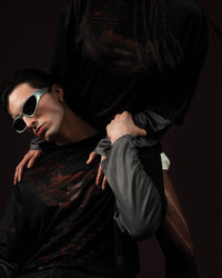 Zica Bella Bloodzic Jersey 01 black oversized streetwear jersey with red graphic styled on male and female models in editorial interaction pose